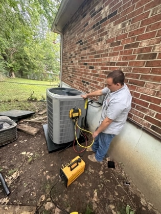 Steve's tech checking the outdoor AC unit